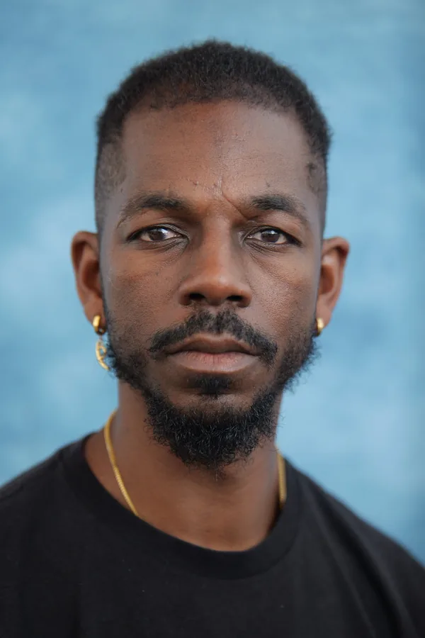 Close professional headshot against a blue background