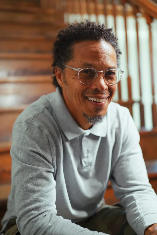 Warm environmental portrait of a smiling creative professional wearing glasses